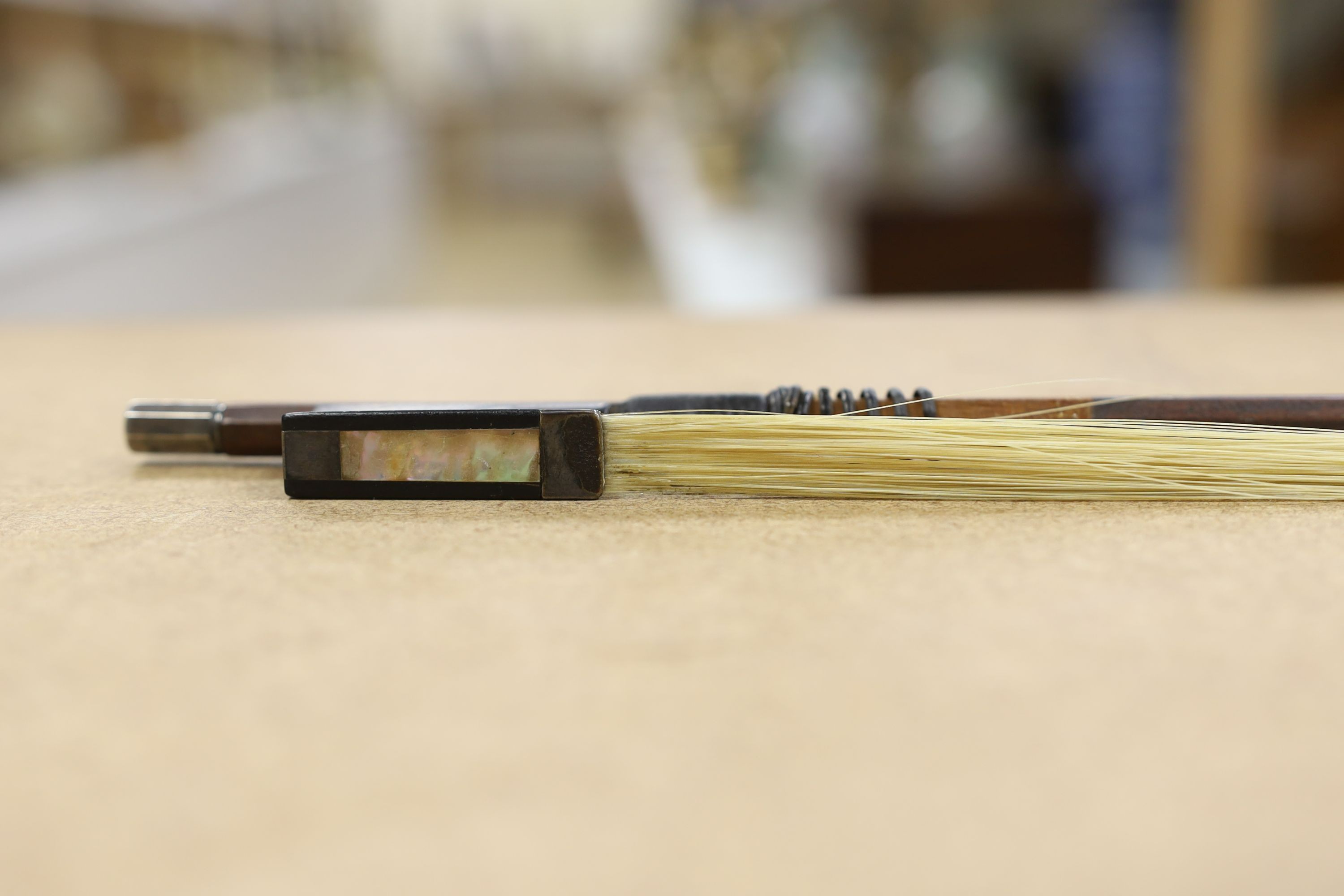 A 19th century violin with 14 inch 2 piece back, unlabelled, cased with silver mounted bow.